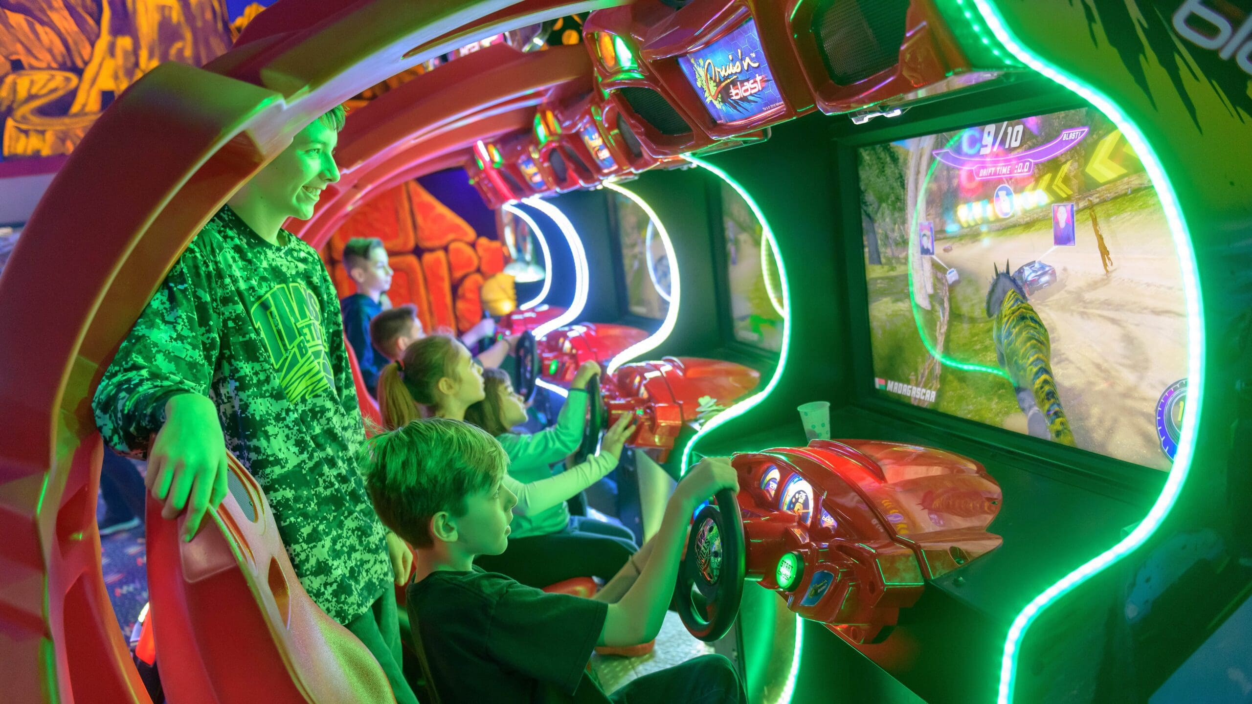 Kids enjoying gaming together in a vibrant game room setting.